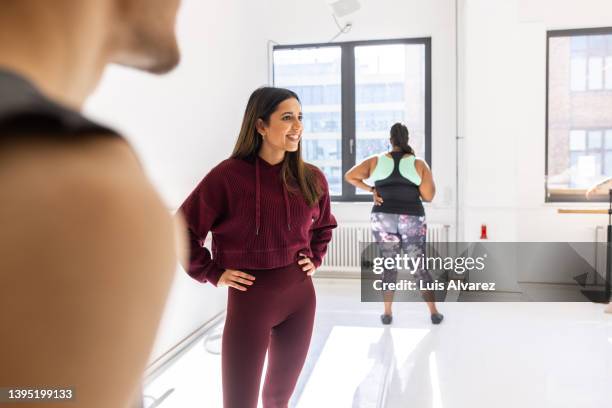 young asian woman talking with friends at fitness sance studio - sri lankan ethnicity stock pictures, royalty-free photos & images