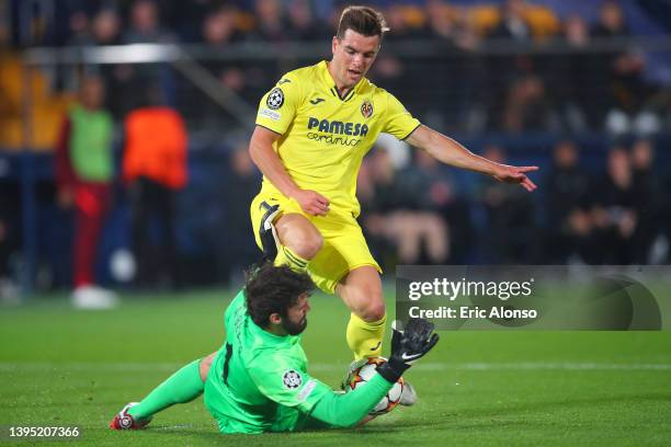 Giovani Lo Celso of Villarreal CF is challenged by Alisson Becker of Liverpool during the UEFA Champions League Semi Final Leg Two match between...