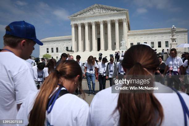 Students and parents from the Wickenberg Christian Academy, in Wickenberg, Arizona, pray in front of the U.S. Supreme Court Building on May 03, 2022...