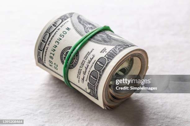 rolled american dollars banknotes on table. - slovakia money stock pictures, royalty-free photos & images