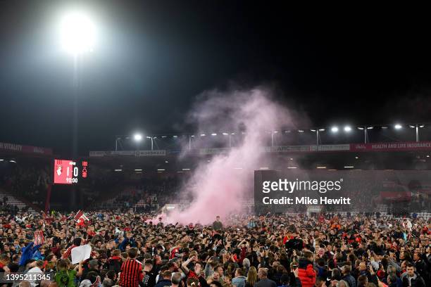 Bournemouth fans celebrate on the pitch after their sides victory and promotion to the Premier League during the Sky Bet Championship match between...