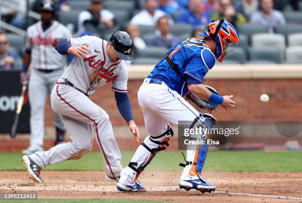 Tomas Nido of the New York Mets is unable to make the tag as Adam Duvall of the Atlanta Braves scores in the second inning at Citi Field on May 03,...