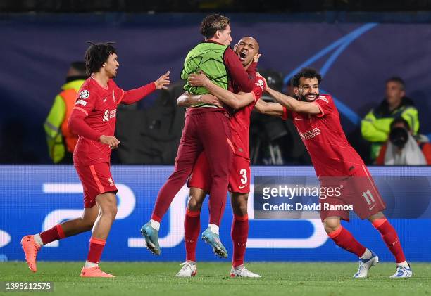Fabinho celebrates with teammates Kostas Tsimikas, Mohamed Salah and Trent Alexander-Arnold of Liverpool after scoring their team's first goal during...