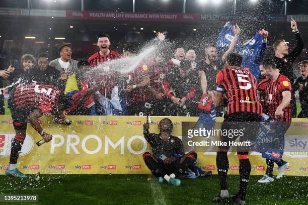 Bournemouth players celebrate after their sides victory and promotion to the Premier League during the Sky Bet Championship match between AFC...