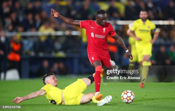 Sadio Mane of Liverpool evades a tackle from Juan Foyth of Villarreal CF before scoring their sides third goal during the UEFA Champions League Semi...
