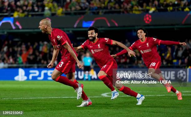 Fabinho celebrates with teammates Mohamed Salah and Trent Alexander-Arnold of Liverpool after scoring their team's second goal during the UEFA...
