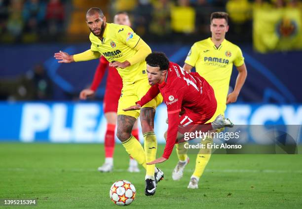 Etienne Capoue of Villarreal CF fouls Curtis Jones of Liverpool and receives a red card during the UEFA Champions League Semi Final Leg Two match...