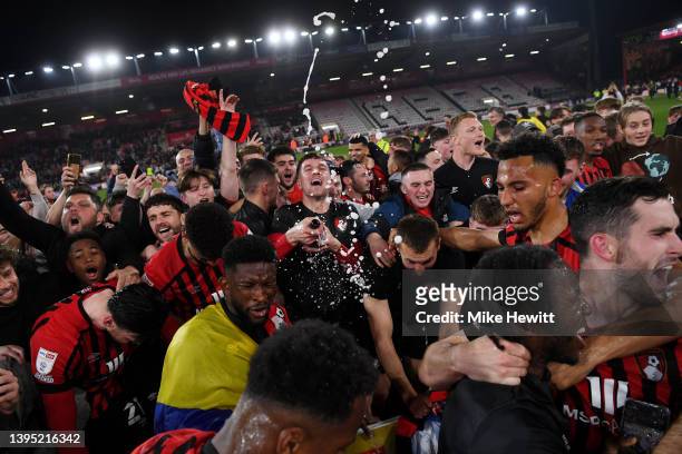 Bournemouth players celebrate with the fans after their sides victory and promotion to the Premier League during the Sky Bet Championship match...