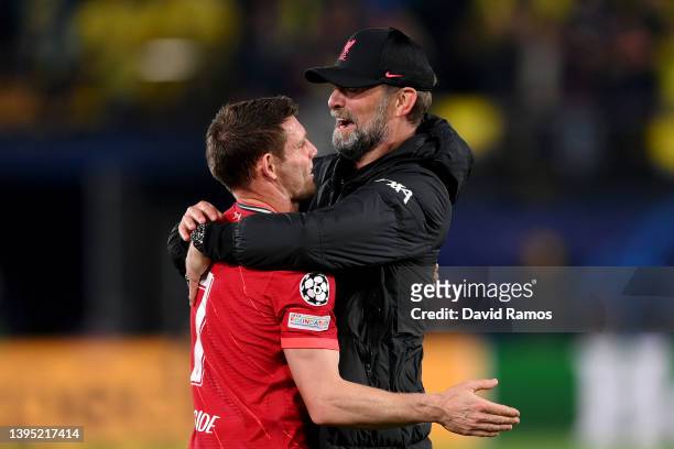 Juergen Klopp embraces James Milner of Liverpool after their sides victory during the UEFA Champions League Semi Final Leg Two match between...