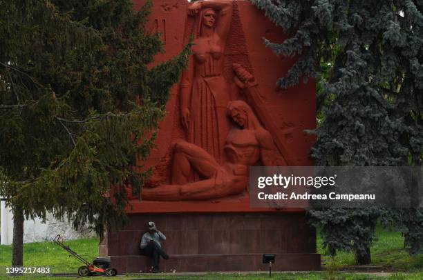 Man rests on a statues, part of Eternity Memorial Complex, in the memory of the Soviet soldiers who died in WWII, on May 3, 2022 in Chisinau,...