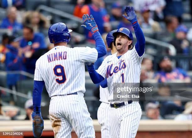 Brandon Nimmo and Jeff McNeil of the New York Mets celebrate after they both scored off a double from teammate Dominic Smith in the first inning...