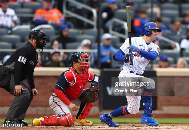 Brandon Nimmo of the New York Mets hits in the first inning as William Contreras of the Atlanta Braves defends during game two of a double header at...