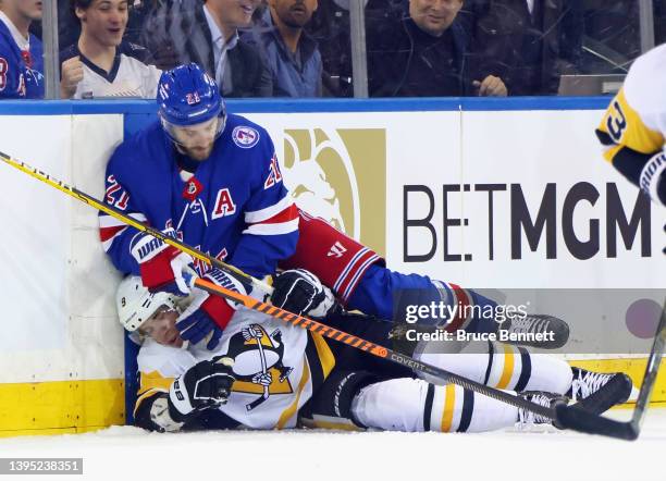Barclay Goodrow of the New York Rangers lands on top of Evan Rodrigues of the Pittsburgh Penguins during the first period in Game One of the First...