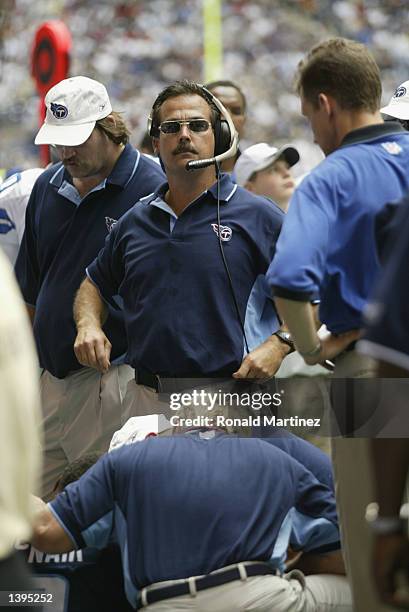 Jeff Fisher head coach of the Tennessee Titans stands over injured quarterback Steve McNair during the game against the Dallas Cowboys on September...