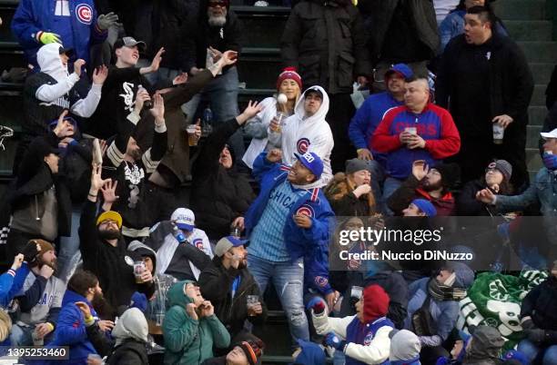 Fans in the right field bleachers try to catch the home run ball hit by Tim Anderson of the Chicago White Sox during the third inning of a game...