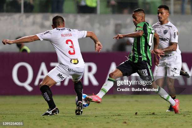 Junior Alonso of Atletico Mineiro fights for the ball with Paulinho Boia of America MG during the match between Atletico Mineiro and America MG as...