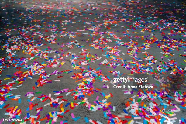 many multi colored confetti on concrete floor after party. concept of celebration event ending - after party mess stock pictures, royalty-free photos & images