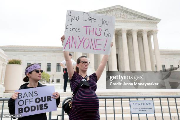 Pro-choice activists demonstrate in front of the U.S. Supreme Court Building in response to the leaked Supreme Court draft decision to overturn Roe...