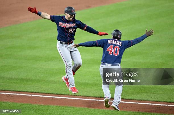 Ryan Jeffers of the Minnesota Twins celebrates with third base coach Tommy Watkins after hitting a three-run home run in the sixth inning against the...