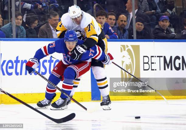 Evgeni Malkin of the Pittsburgh Penguins holds on to Frank Vatrano of the New York Rangers during the first overtime period in Game One of the First...