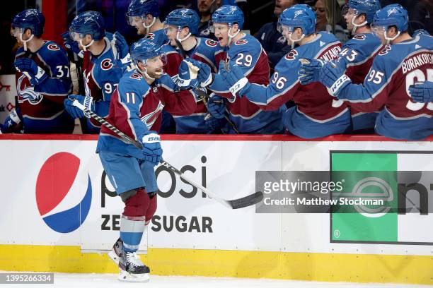 Andrew Cogliano of the Colorado Avalanche is congratulated by his teammates after scoring a goal against the Nashville Predators in the first period...
