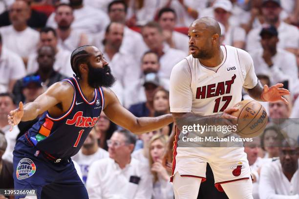 Tucker of the Miami Heat is defended by James Harden of the Philadelphia 76ers during the first half in Game One of the Eastern Conference Semifinals...