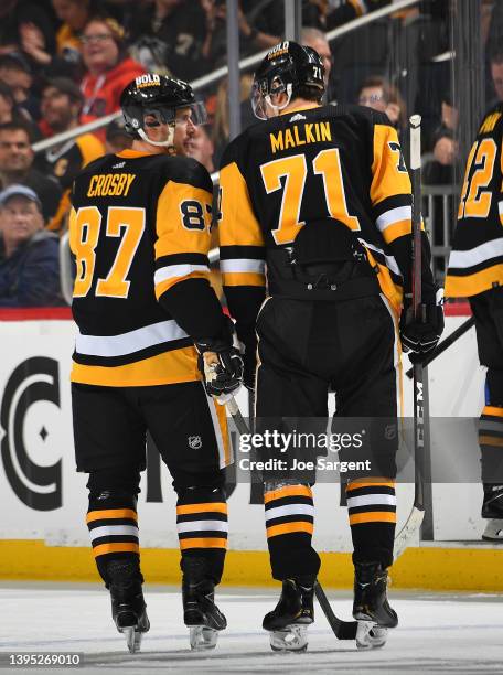 Sidney Crosby talks with Evgeni Malkin of the Pittsburgh Penguins during the game against the Edmonton Oilers at PPG PAINTS Arena on April 26, 2022...