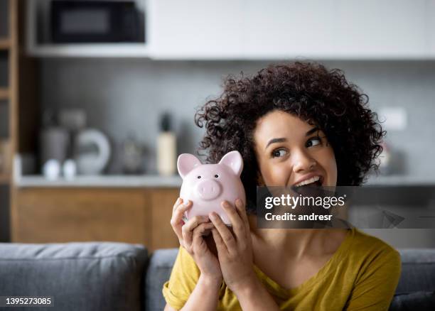 woman ready to open her piggy bank - saving stock pictures, royalty-free photos & images