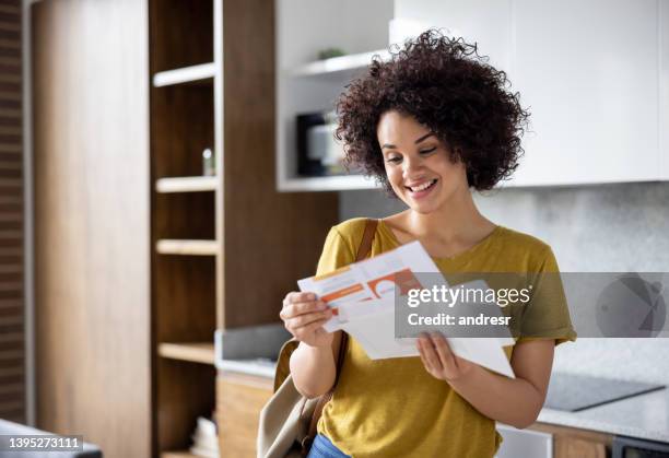 happy woman checking the mail while arriving home - mail stock pictures, royalty-free photos & images