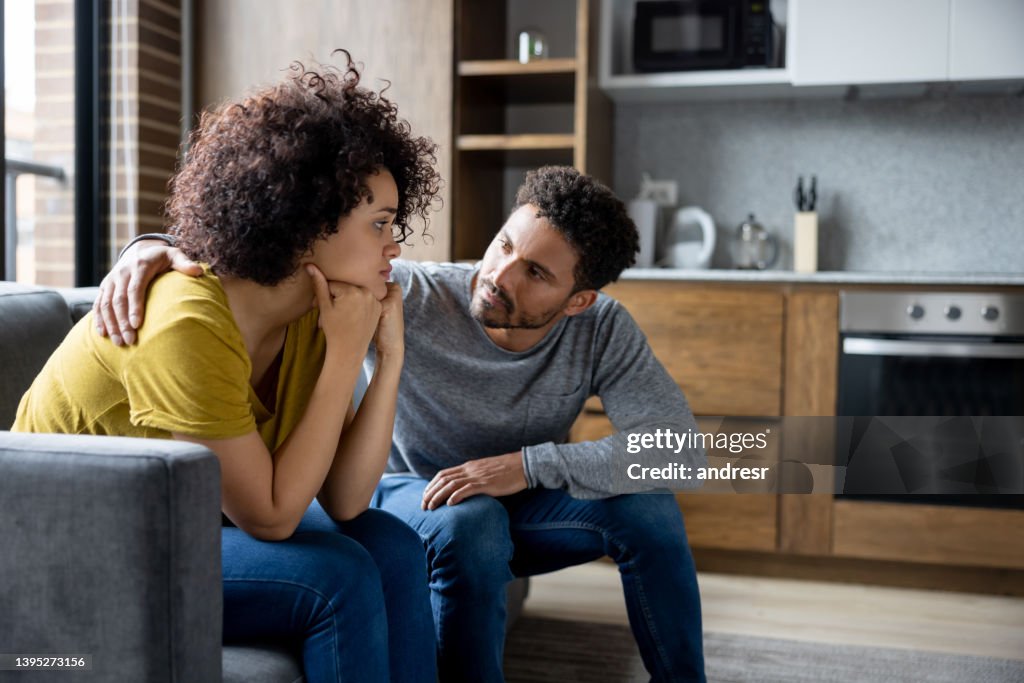Man comforting his girlfriend at home