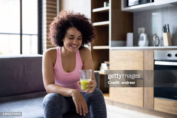 healthy woman drinking a green smoothie - shaking drink stock pictures, royalty-free photos & images