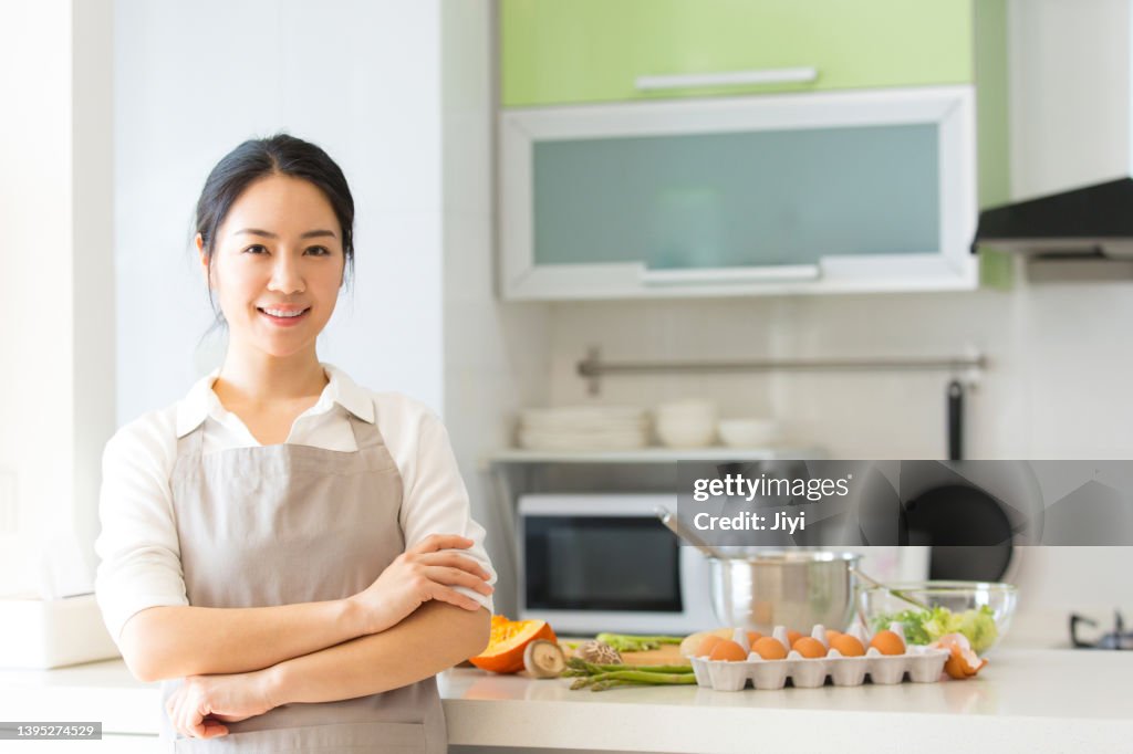 Young housewife or chef who preparing egg food in a family kitchen - stock photo