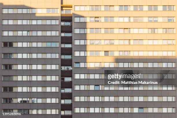 berlin city symmetry plattenbau residential building with shadow and sun light mix - berlin modernism housing estates stock pictures, royalty-free photos & images