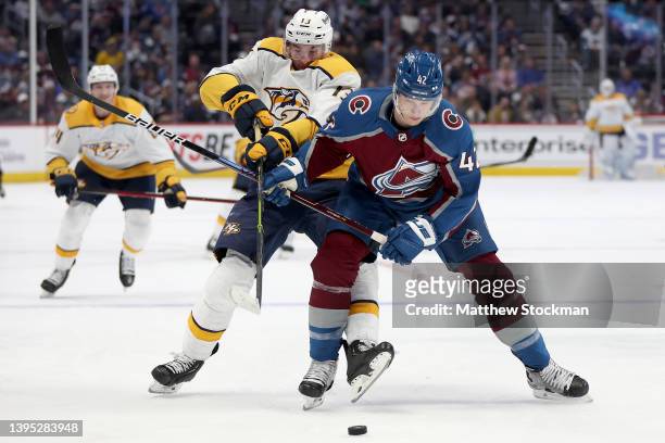 Yakov Trenin of the Nashville Predators fights for the puck against Josh Manson of the Colorado Avalanche in the third period during Game One of the...