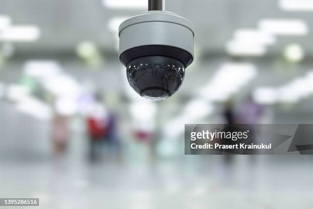 modern cctv camera on a wall in a modern building - digital camcorder stock pictures, royalty-free photos & images