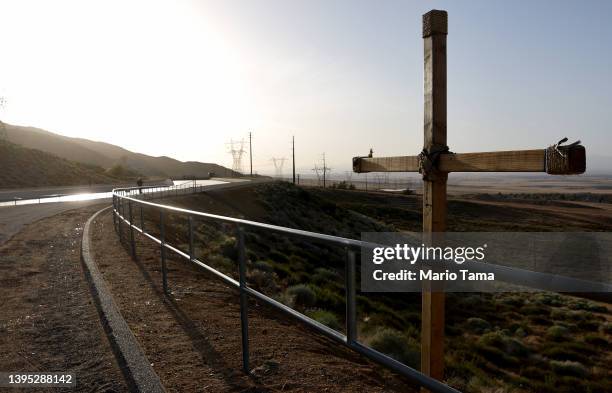 Cross is displayed along the California Aqueduct, which moves water from northern California to the state's drier south, on May 3, 2022 in Palmdale,...