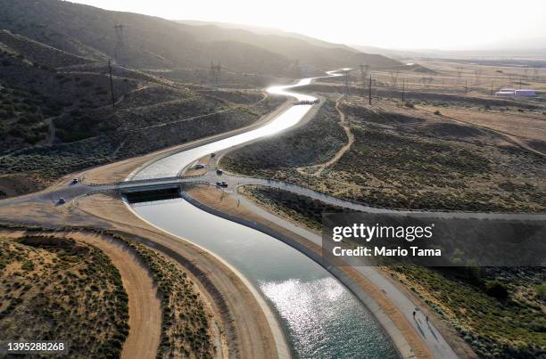 An aerial view of people walking along the California Aqueduct, which moves water from northern California to the state's drier south, on May 3, 2022...