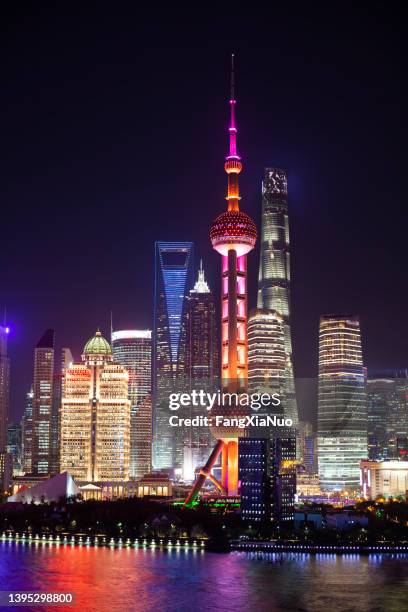 shanghai's pudong district's skyscrapers at night, oriental pearl tower, shanghai world financial center, shanghai tower, and jin mao tower - shanghai stock pictures, royalty-free photos & images