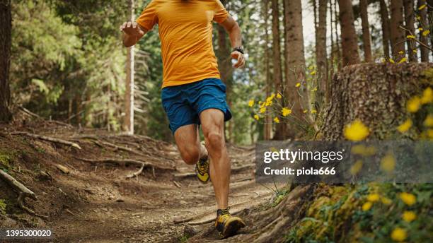 man trail running on mountain: the dolomites - trackmen stock pictures, royalty-free photos & images