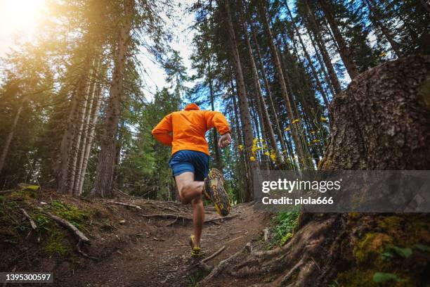 man trail running on mountain: the dolomites - trailrunning stock pictures, royalty-free photos & images