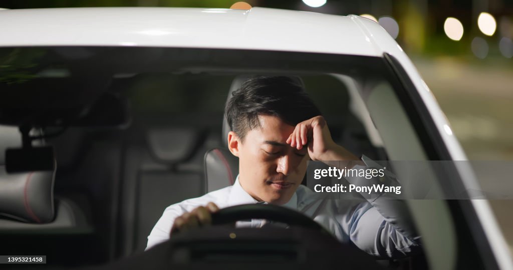 Man feel depressed in car