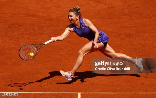 Simona Halep of Romania plays a forehand in her quarterfinal match against Ons Jabeur of Tunisia during day seven of the Mutua Madrid Open at La Caja...