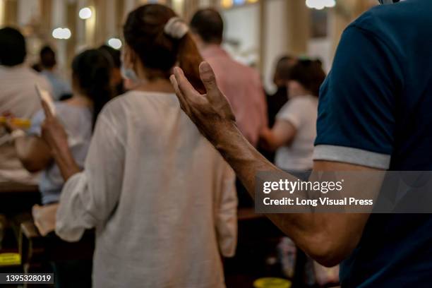 People attend the Sacrament of Eucharist Mass during the holy week celebrations in Colombia in Villavicencio, Colombia on April 14, 2022.