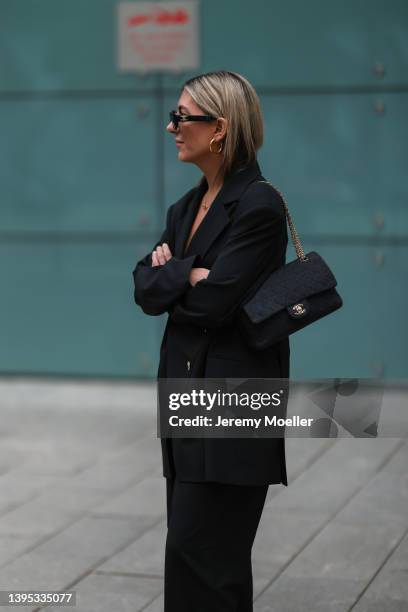 Aylin König wearing black shades, a black oversize Blazer, a black Chanel bag, black pants and attends the Copenhagen Studios Store Opening on April...