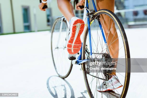 woman on racing bike ready to ride in the city - bike pedal stock pictures, royalty-free photos & images