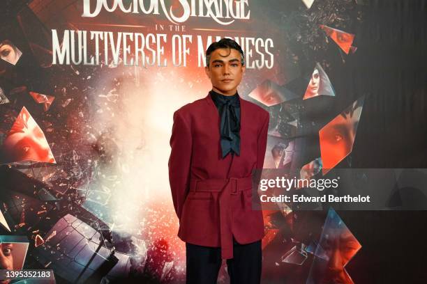 Fabian CRF @fabiancrfx wears a black silk scarf, a burgundy kimono jacket with shoulder pads and a belt, suit pants, the "Doctor Strange In The...