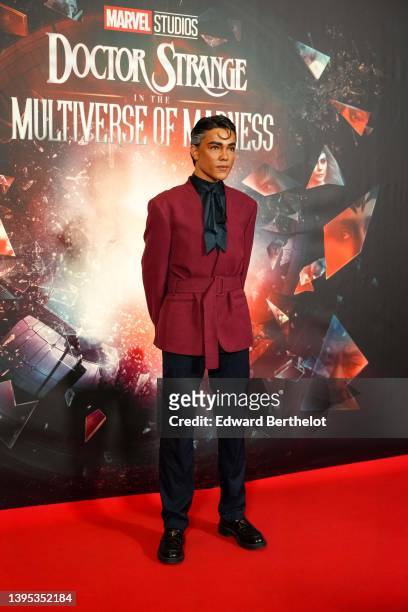 Fabian CRF @fabiancrfx wears a black silk scarf, a burgundy kimono jacket with shoulder pads and a belt, suit pants, the "Doctor Strange In The...