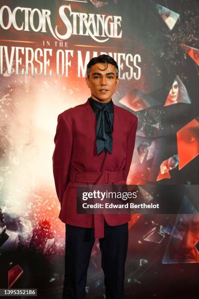 Fabian CRF @fabiancrfx wears a black silk scarf, a burgundy kimono jacket with shoulder pads and a belt, suit pants, the "Doctor Strange In The...