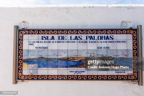 ceramic sign showing the geographical location of the isla de las palomas in tarifa, spain. - tarifa moors stock pictures, royalty-free photos & images