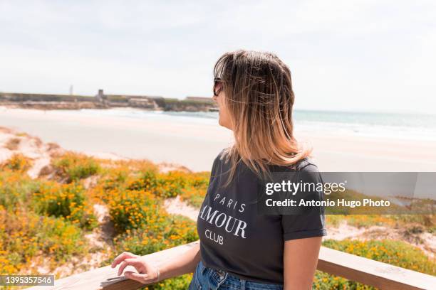 portrait of a woman with sunglasses on a beach. - tarifa moors stock pictures, royalty-free photos & images